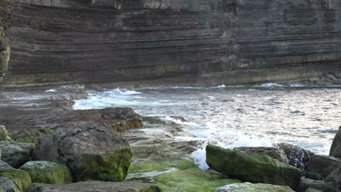 Waves beating the cliff in the evening Stock Footage 146900948