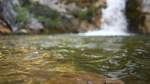 Waves on a beautiful pool of a waterfall in summer (slow motion) Video stock 219387936