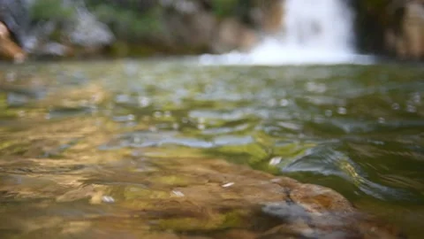 Waves on a beautiful pool of a waterfall in summer (bokeh, slow motion) Stock-Footage 219418504