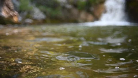 Waves on a beautiful pool of a waterfall in summer (bokeh, slow motion) 스톡 동영상 219418623