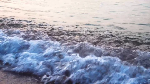 Waves on a beautiful sandy beach at sunset. Peace and harmony. Stock Footage 95035489