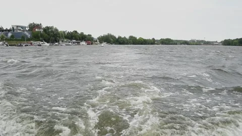 Waves behind a boat on the river Video stock 306173360