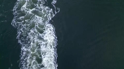 Waves behind boat on water Stock Footage 244438046