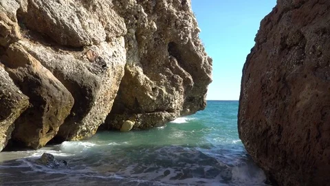 Waves between the cliffs in Nerja, Spain Stock Footage 82549371