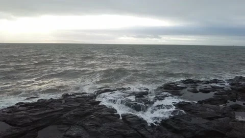 Waves black rocks sunset 4k Stock Footage 179487024