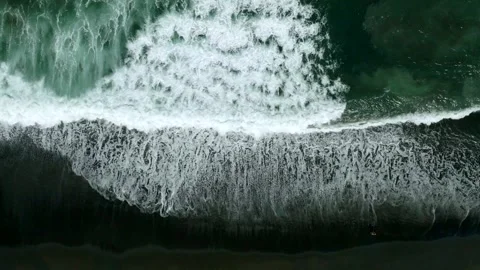 Waves on black sand beach in Bali. Slow motion. Drone view 스톡 동영상 246614082