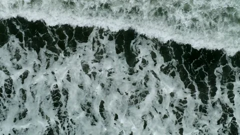 Waves on black sand beach in Bali. Slow motion. Drone view Stock Footage 246614138