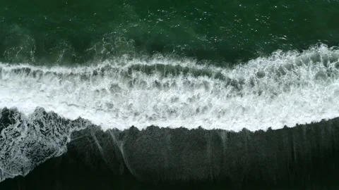 Waves on black sand beach in Bali. Slow motion. Drone view 스톡 동영상 246614169