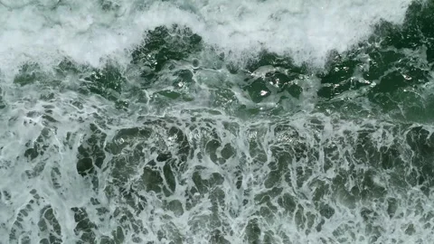 Waves on black sand beach in Bali. Slow motion. Drone view Stock Footage 246660202