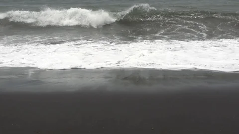 Waves on the black sand beach in cloudy weather. Stock Footage 104404027