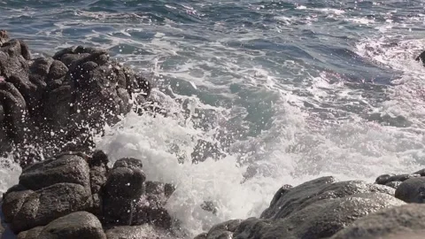 Waves on bleach with blue sky and rocks in sea, 2 times slow motion Stock Footage 165998430