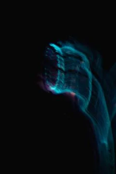 Waves of blue neon light in the dark Stock Photos