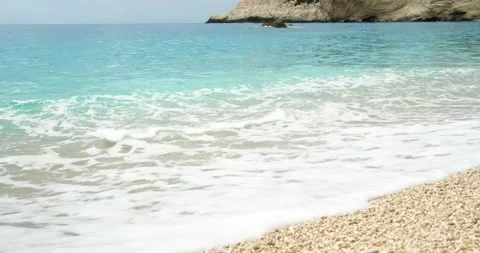 Waves of blue sea crushing on beach with white pebbles. Stock Footage 156418536