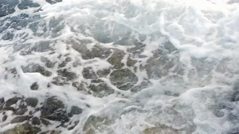 Waves in the blue sea hitting the rocks in slow motion Stock Footage 130294543