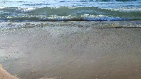Waves blue transparent water rolling onto the sand of a sandy beach Stock Footage 323127969