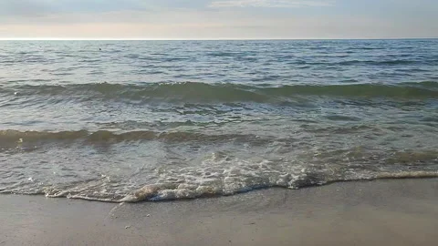Waves blue transparent water rolling onto the sand of a sandy beach Stock Footage 324985452