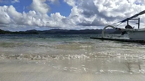 Waves, Boat and Blue Sky on a beach in Lombok Indonesia Video stock 242558416