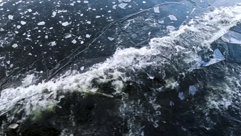 Waves from a boat sailing on a cold winter river Stock Footage 306548116