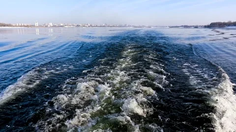 Waves from a boat sailing on a cold winter river Stock Footage 321612252