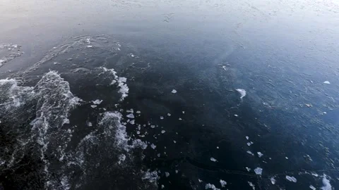 Waves from a boat sailing on a cold winter river Stock Footage 321612274