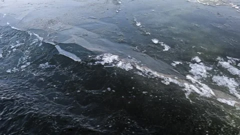 Waves from a boat sailing on a cold winter river Stock Footage 324855024