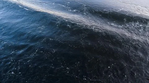 Waves from a boat sailing on a cold winter river Stock Footage 328228515