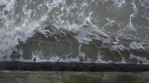 Waves break about the pier pile Stockbeeldmateriaal 89134928