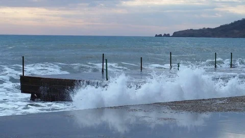 Waves break about the quay and soar upwards Stock Footage 84545962