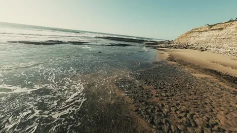 Waves break across rugged coast Stock Footage 339791373
