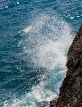 Waves break against the rock Stock Photos