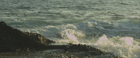Waves break against rocks at sunset, 3K, Anamorphic, Red Stock Footage 46017482