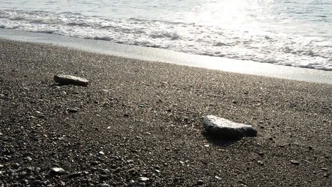 The waves break on the beach early in the day Stock Footage 84007601