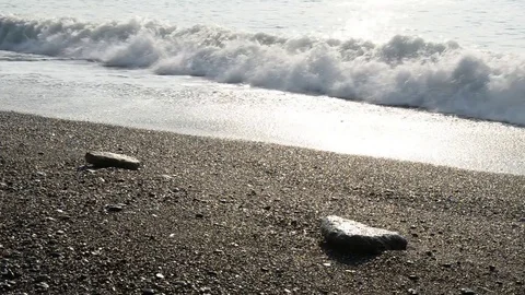 The waves break on the beach early in the day Stock Footage 84008184
