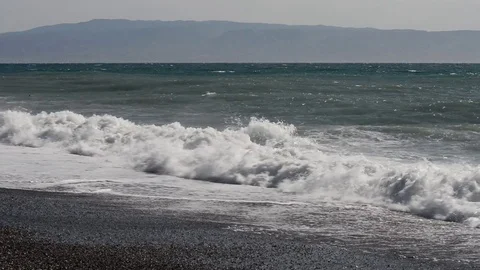 The waves break on the beach on a windy and sunny day Stock Footage 84025685
