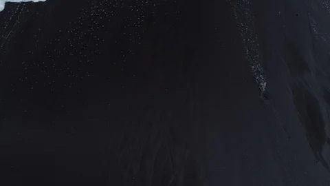 Waves break on a black sand beach on the coast of Maderia Island, Portugal Stock Footage 101332234