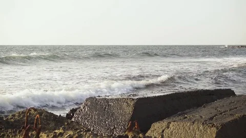 Waves break on concrete blocks Stock Footage 82528155
