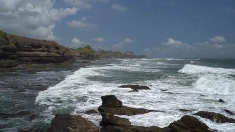 Waves break on dark rocks near beach Sea waves on the stones Stock Footage 119225357