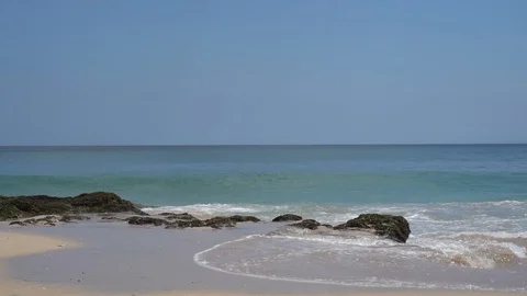 Waves break on dark rocks near beach Sea waves on the stones Video stock 119225461