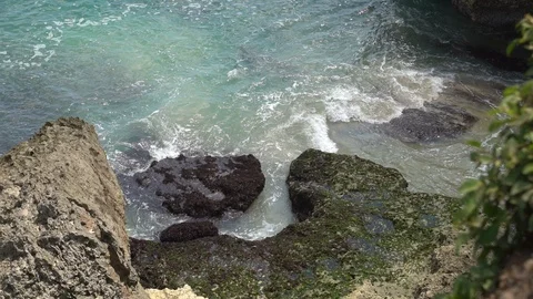 Waves break on dark rocks near beach Sea waves on the stones Stock Footage 119225516