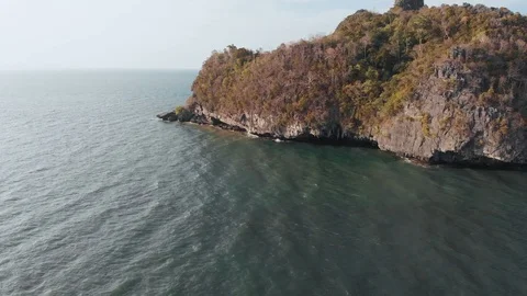 The waves break on large rocks, smoothly opens the view of the Strait of Malacca Stock Footage 106824577