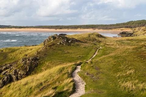 Waves break onto Malltraeth Sands Stock Photos