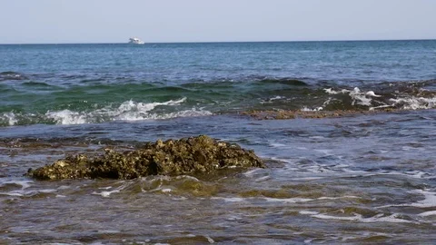 Waves break over rock in slow motion Stock Footage 98179719