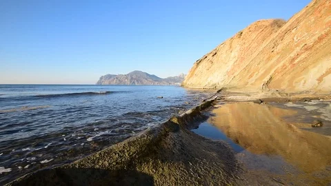 Waves break over stone on the beach. Stock Footage 97739224