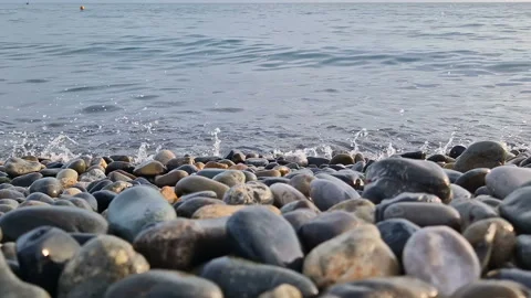 Waves break on the rocks on the beach, sea spray, sunlight is reflected in the Stock Footage 280168510