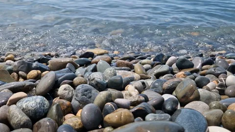 Waves break on the rocks on the beach, sea spray, sunlight is reflected in the Stock Footage 280168804