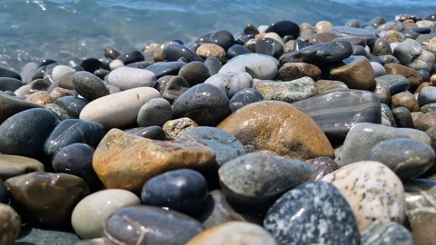 Waves break on the rocks on the beach, sea spray, sunlight is reflected in the Stock Footage 280583697