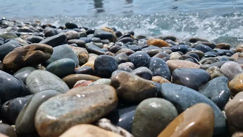 Waves break on the rocks on the beach, sea spray, sunlight is reflected in the Stock Footage 280583926