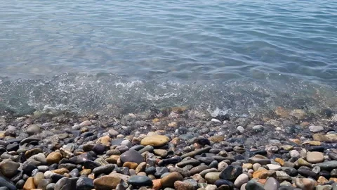 Waves break on the rocks on the beach, sea spray, sunlight is reflected in the Stock Footage 280584063