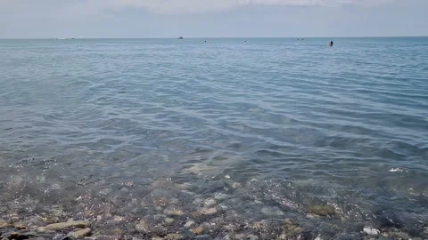 Waves break on the rocks on the beach, sea spray, sunlight is reflected in the Stock Footage 280584764
