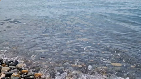Waves break on the rocks on the beach, sea spray, sunlight is reflected in the Stock Footage 280585441